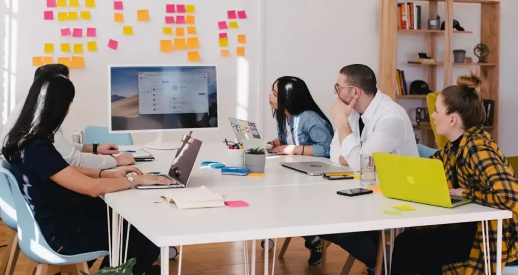 A team in an office discussing customer journey orchestration platforms during a meeting