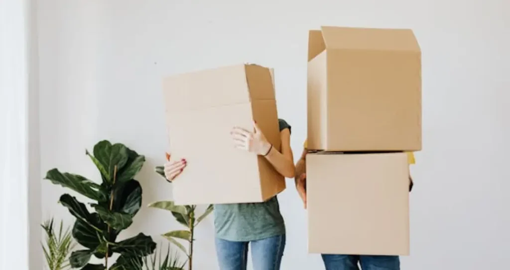 Couple carrying boxes