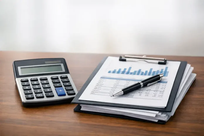 1772254345457_7267 Calculator and financial report on clipboard