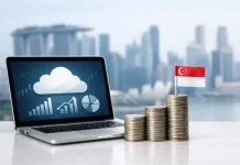 The Growing Importance of Cloud Financial Systems for Startups in Singapore Laptop with charts and Singapore flag coins
